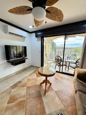 a living room with a ceiling fan and a tv at Relaxing 1BR Oasis near Tamarindo in Villarreal