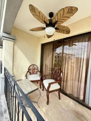 a porch with two chairs and a ceiling fan at Relaxing 1BR Oasis near Tamarindo in Villarreal