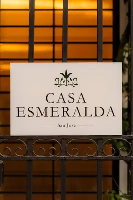 a sign on a gate in front of a building at Habitación doble económica - Casa Esmeralda in San José