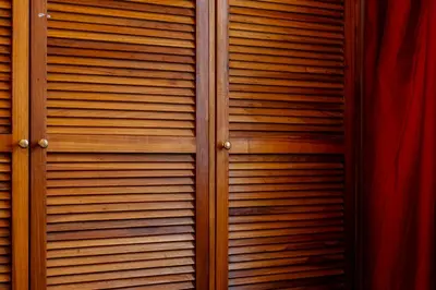 a wooden door with wood panels on it at Habitación triple confort - Casa Esmeralda in San José