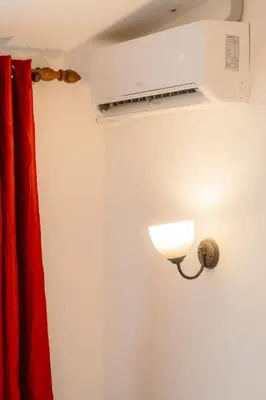 a room with a heater and a red curtain at Habitación triple confort - Casa Esmeralda in San José