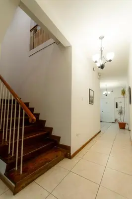 a hallway with stairs in a house at Habitación doble delux - Casa Esmeralda in San José
