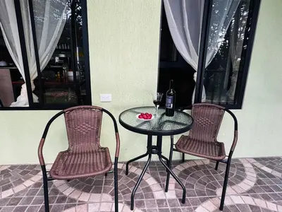 a table with two chairs and a bottle of wine at Cabina de las Hojas Monteverde in Monteverde Costa Rica