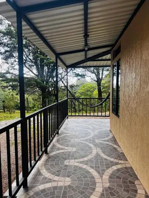 a balcony of a house with a fence at Cabina de las Hojas Monteverde in Monteverde Costa Rica