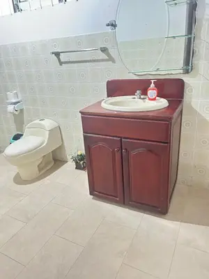 a bathroom with a sink and a toilet and a mirror at Doucemaison in Tilarán