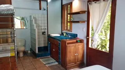 a bathroom with a sink and a toilet at Casa Selva in Dominicalito