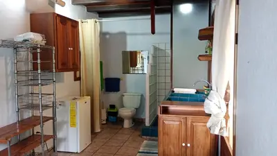 a small kitchen with a sink and a toilet at Casa Selva in Dominicalito