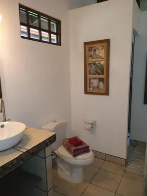 a bathroom with a toilet and a sink at Casas Buenas Brisas in Ojochal