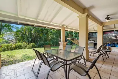 a patio with a glass table and chairs at Ocean View Condo with Resort Style Pool in Tamarindo
