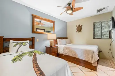 a bedroom with two beds and a ceiling fan at Ocean View Condo with Resort Style Pool in Tamarindo