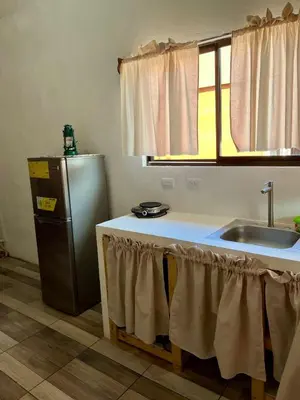 a kitchen with a sink and a refrigerator at Cabaña Hojancha in Hojancha