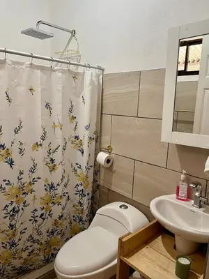 a bathroom with a toilet and a sink at Cabaña Hojancha in Hojancha