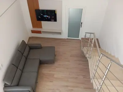 a living room with a couch and a staircase at T Loft in Playa Hermosa