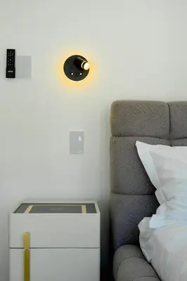 a bedroom with a bed and a light on the wall at T Loft in Playa Hermosa