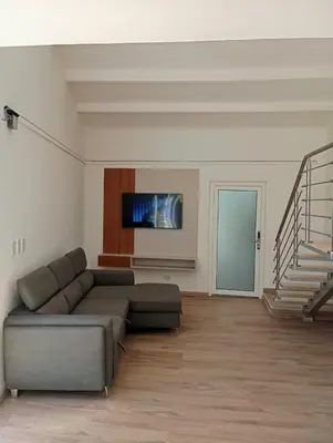 a living room with a couch and a flat screen tv at T Loft in Playa Hermosa