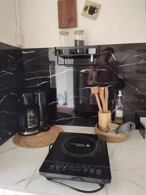a kitchen counter with a coffee maker and a blender at La casita de Nana in Esparza