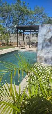 a swimming pool with a gazebo and a bench at Casa Mathi in Portegolpe