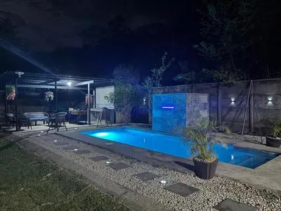 a swimming pool in a backyard at night at Casa Mathi in Portegolpe