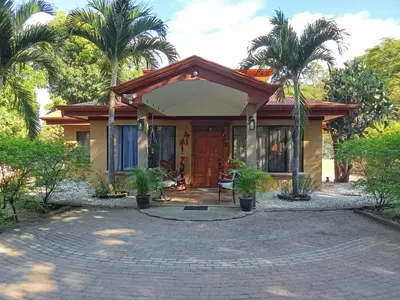 a house with palm trees in front of it at Casa Mathi in Portegolpe