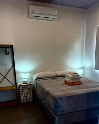 a bedroom with a bed and a air conditioner at Finca Dontricia Official in Cañas Dulces