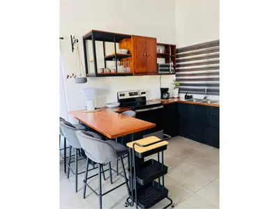 a kitchen with a wooden table and chairs at Finca Dontricia Official in Cañas Dulces