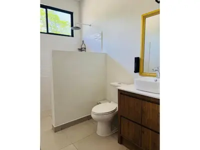 a bathroom with a toilet and a sink and a mirror at Finca Dontricia Official in Cañas Dulces