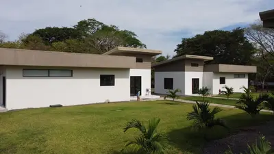 a house with a green lawn in front of it at Finca Dontricia Official in Cañas Dulces