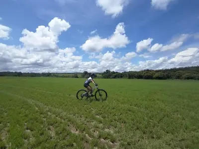a person riding a bike in a field at Finca Dontricia Official in Cañas Dulces