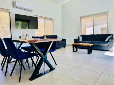 a living room with a table and chairs and a couch at Finca Dontricia Official in Cañas Dulces
