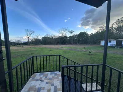 a balcony with a view of a field at ZuGranjita Alojamiento1 in Alajuela City