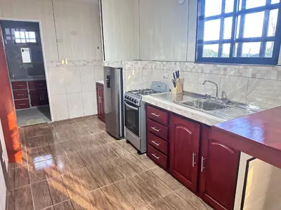 a kitchen with a stove and a sink at ZuGranjita Alojamiento1 in Alajuela City