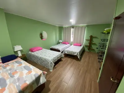 a room with two beds and a ladder in it at Casa Iriria, in harmony with nature in Carpintero
