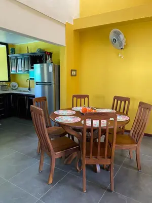 a kitchen with a table and chairs and a refrigerator at Casa Iriria, in harmony with nature in Carpintero