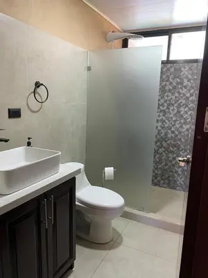 a bathroom with a toilet and a sink and a shower at Casa Iriria, in harmony with nature in Carpintero