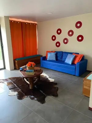 a living room with a blue couch and a table at Casa Iriria, in harmony with nature in Carpintero