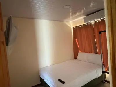 a small bed in a small room on a boat at Bandera Beach Cabins in Parrita