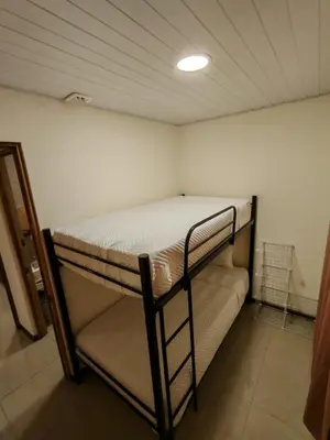 a bedroom with a bunk bed in a room at Bandera Beach Cabins in Parrita