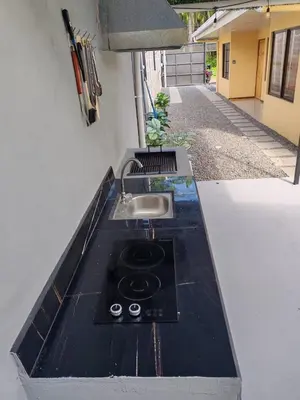 a kitchen counter with a sink and a sink at Bandera Beach Cabins in Parrita