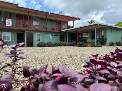 a building with purple flowers in front of it at Hotel Mavi in El Achiote