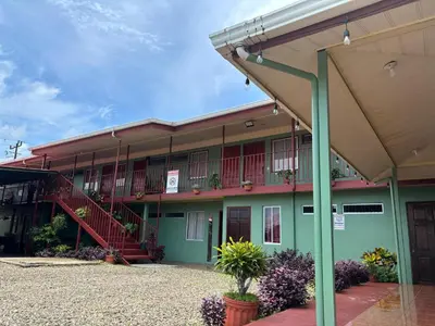 a building with a staircase in front of it at Hotel Mavi in El Achiote