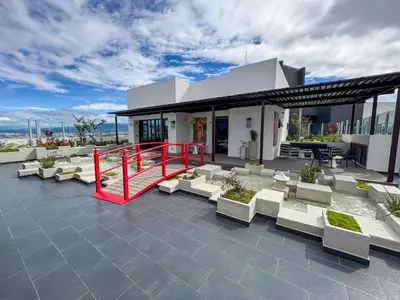 a patio with white chairs and a red railing at Modern Apartment located in Trendy San Jose Condo in San José