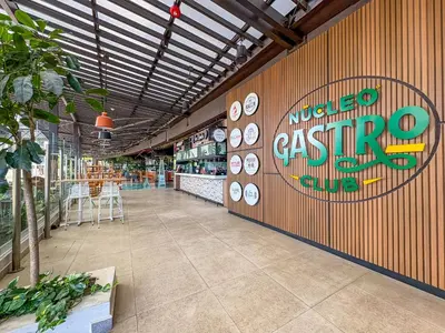 a restaurant with a sign on a wall with clocks at Modern Apartment located in Trendy San Jose Condo in San José