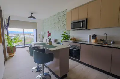 a kitchen with a table and a counter top at Modern Apartment located in Trendy San Jose Condo in San José