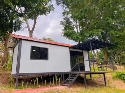 a small house with a staircase in front of it at Jalapa's Rural Container Studio in Tilarán