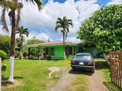 a car parked in front of a green house at Casa de campo Bijagua in Upala
