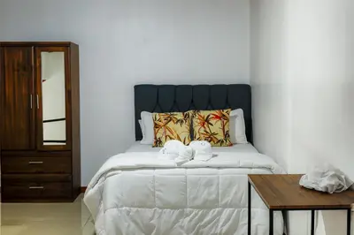 a bedroom with a bed with two towels on it at Apartamento Lantanas in Parrita
