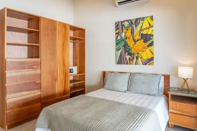 a bedroom with a bed and a painting on the wall at Luxury villa in Samara beach- Casa Armonía in Sámara