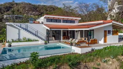 a house with a swimming pool in front of it at Luxury villa in Samara beach- Casa Armonía in Sámara
