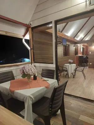 a dining room with a table with flowers on it at Chalet IsaKaEla Volcán Turrialba and Views with charming gardens in Turrialba