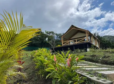 a house on a hill with some plants in front of it at Safari Tent El Cielo in Santa Ana